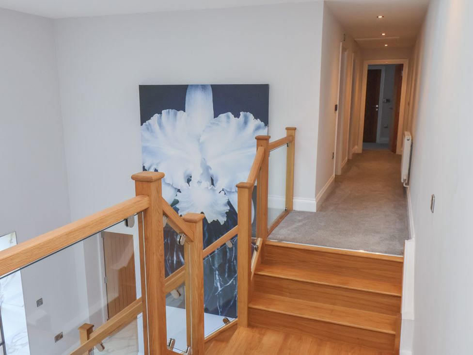 A hallway with stairs and artwork at Courtenay House in Harpham near Nafferton