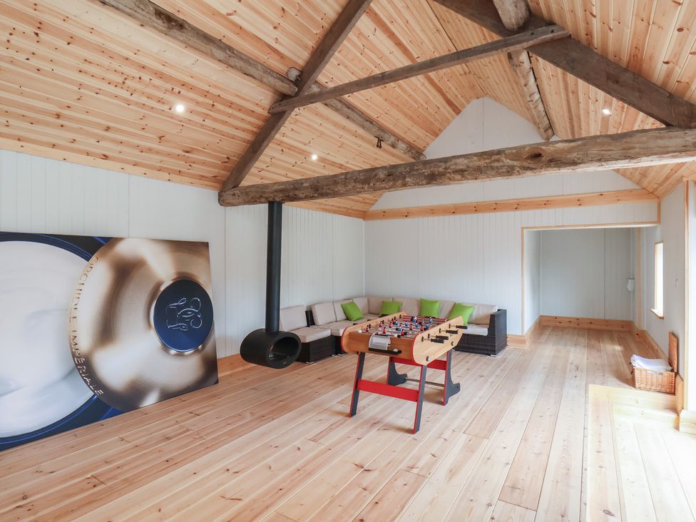 A game room with a foosball table and a sofa at Harpham Manor House in Harpham near Nafferton