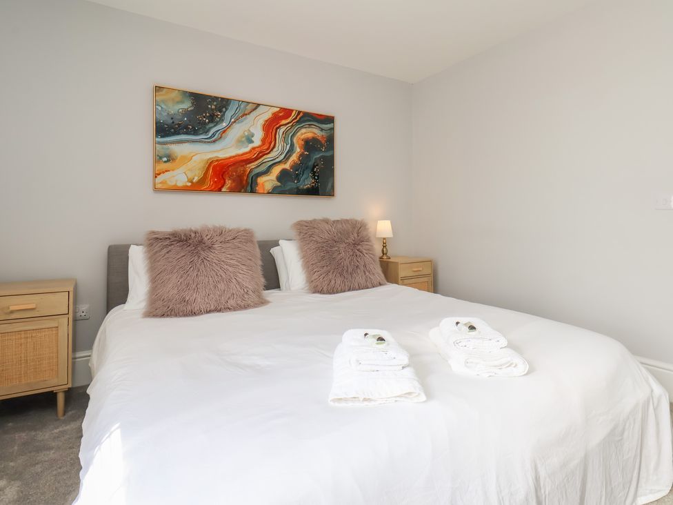 A bedroom with a bed and bedside tables at Harpham Manor House in Harpham near Nafferton