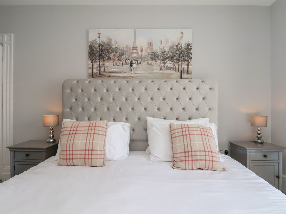 A bedroom with a bed and bedside tables at Harpham Manor House in Harpham near Nafferton