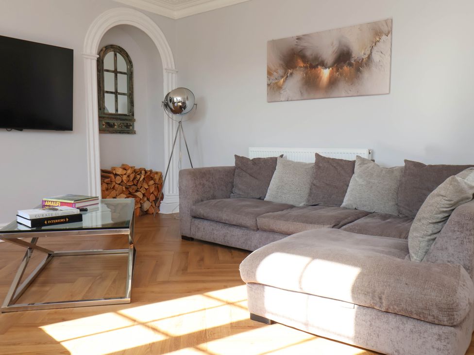 A living room with a sofa and television at Harpham Manor House in Nafferton