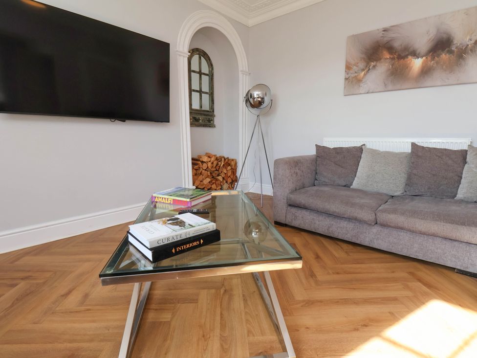A living room with a television and a sofa at Harpham Manor House Nafferton