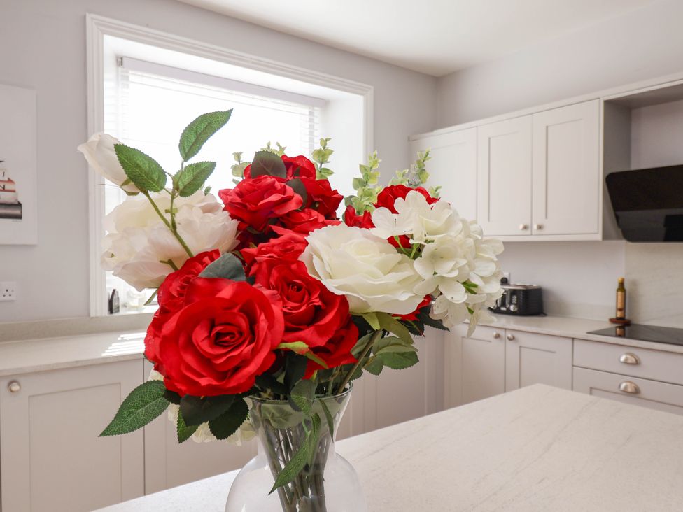 A bouquet of flowers on a countertop in the kitchen at Harpham Manor House in Nafferton