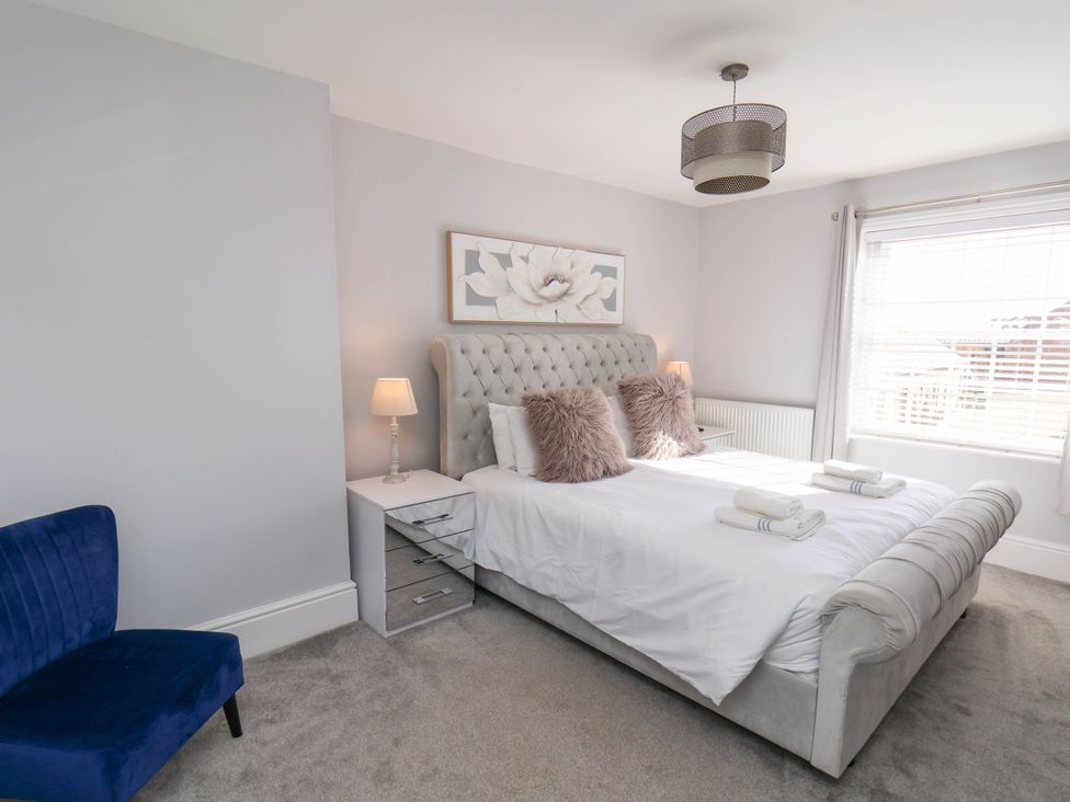 A bedroom with a bed and nightstand at Harpham Manor House in Nafferton