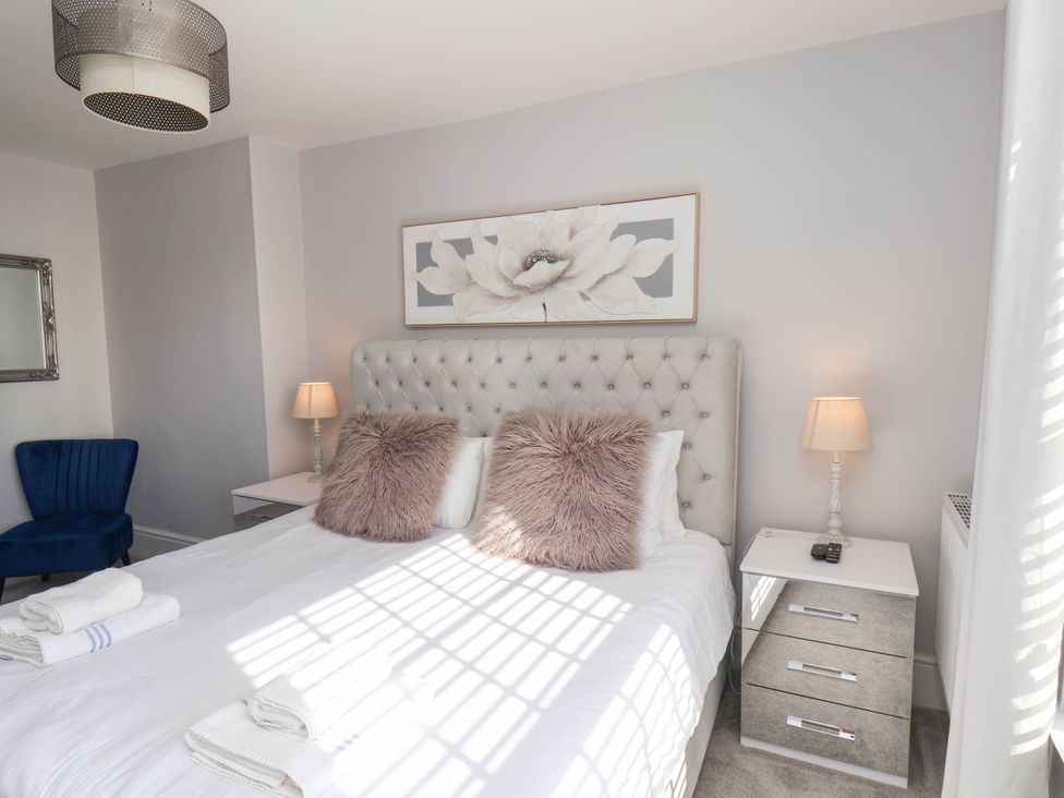 A bedroom with a bed and bedside tables at Harpham Manor House Nafferton