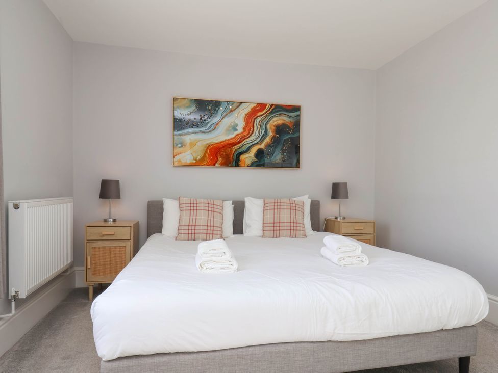 A bedroom with a bed and lamp at Harpham Manor House Nafferton