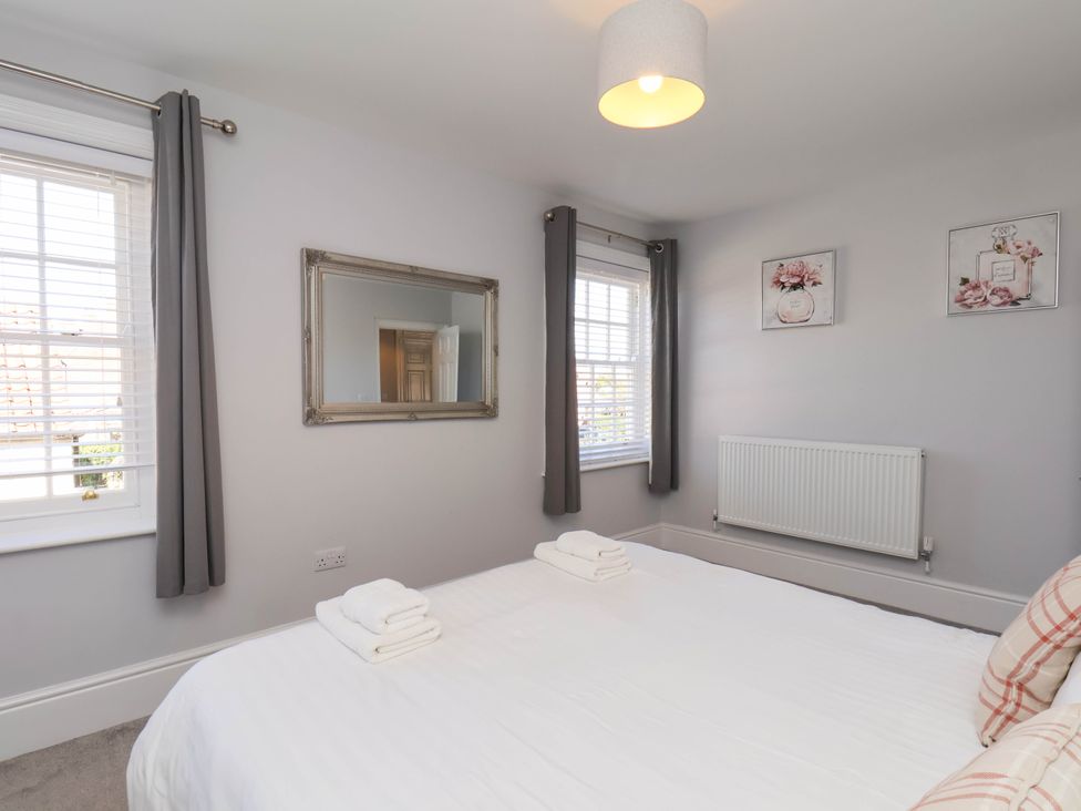 A bedroom with a bed and towels at Harpham Manor House in Nafferton