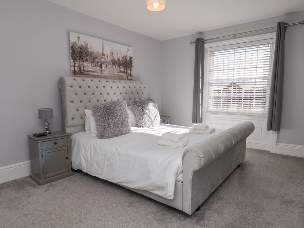 A bedroom with a bed and nightstand at Harpham Manor House Nafferton