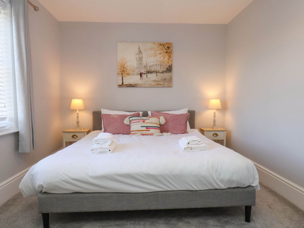 A bedroom with a bed and bedside tables at Harpham Manor House Nafferton