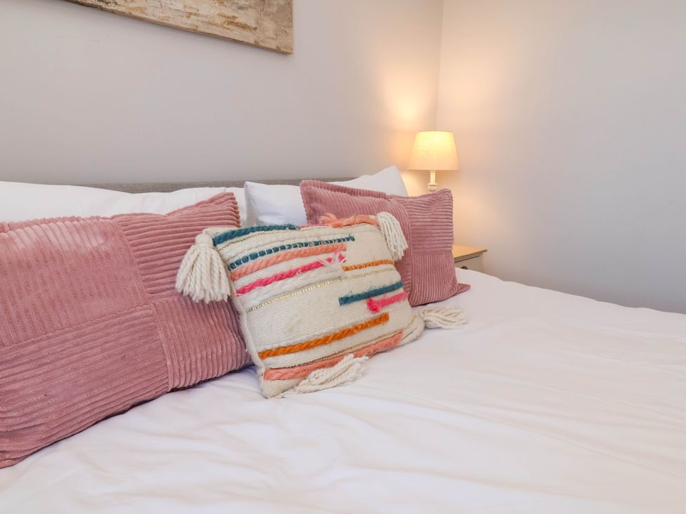 A bedroom with pillows and a lamp at Harpham Manor House in Nafferton
