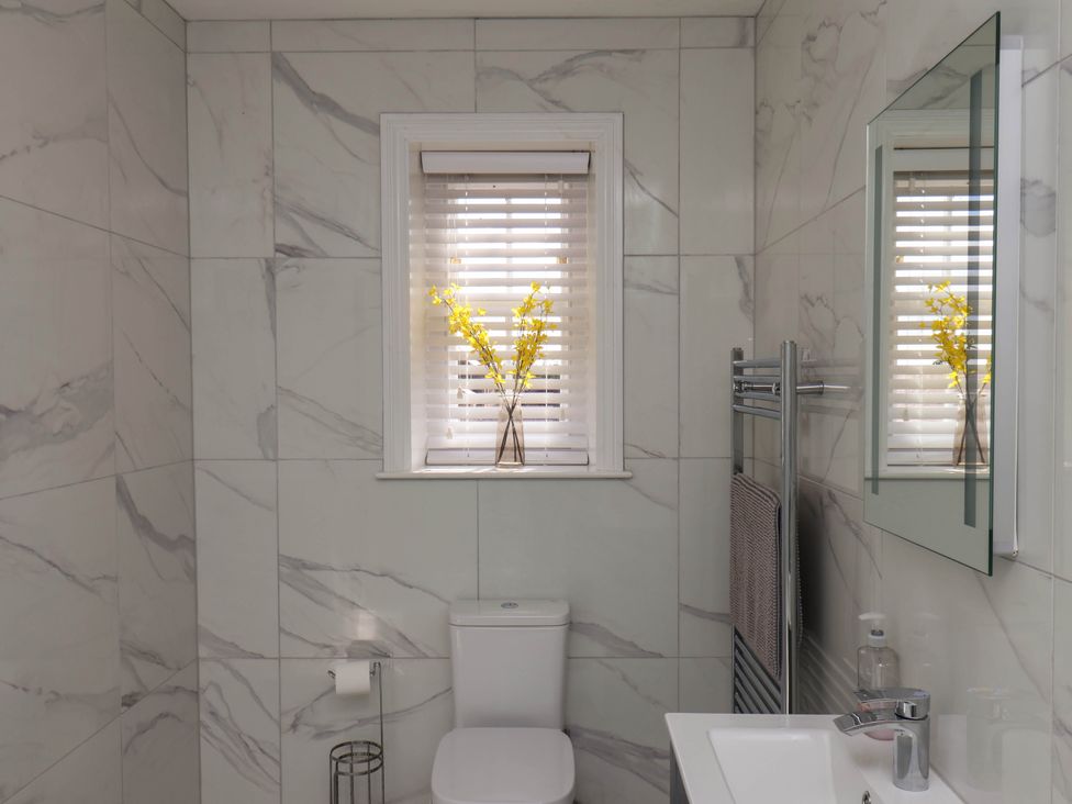 A bathroom with a toilet and sink at Harpham Manor House in Nafferton