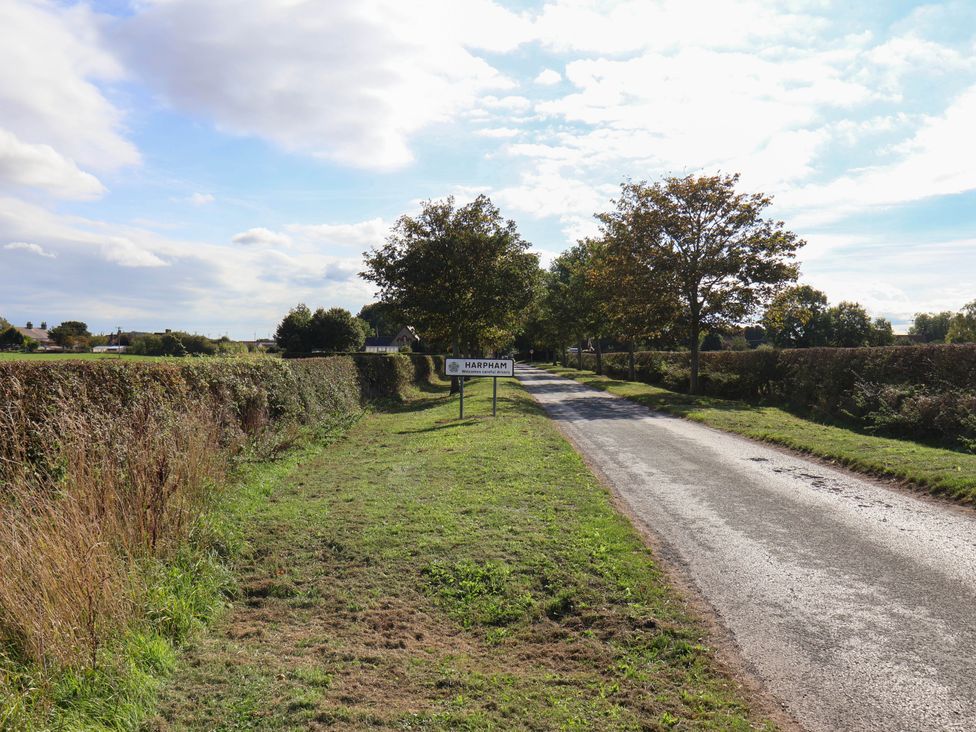 A road with a sign indicating Harpham at Harpham Manor House in Nafferton