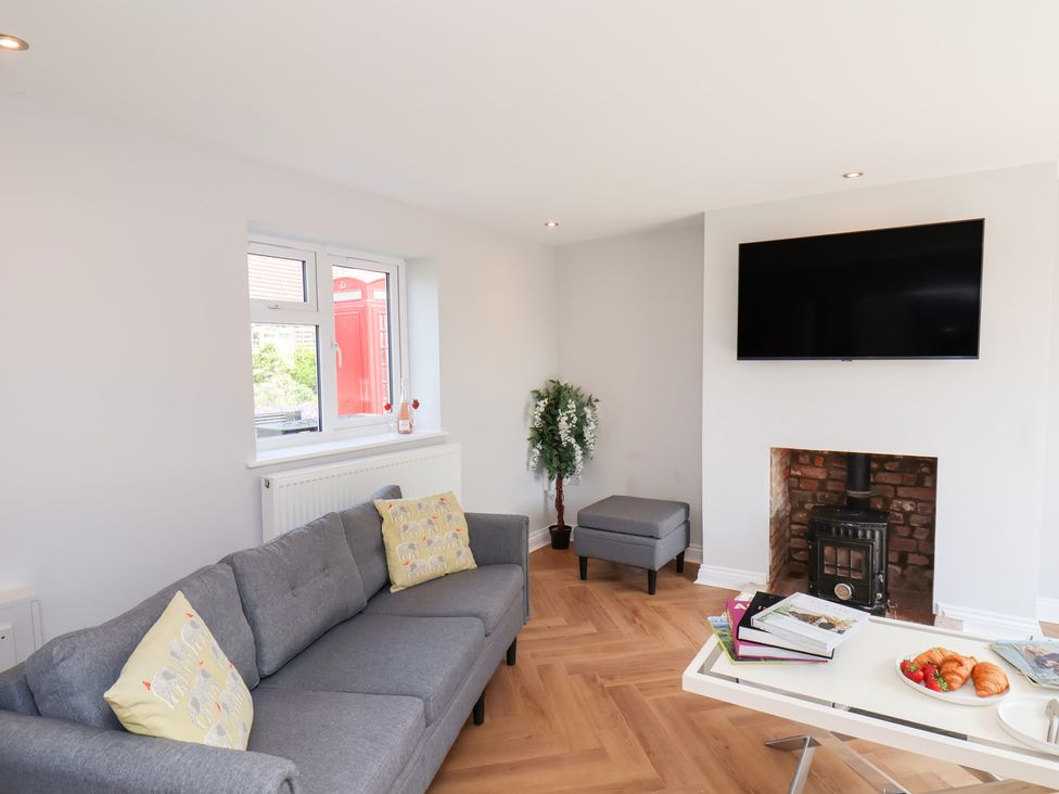 A living room with a sofa and television at Manor Cottage Harpham near Nafferton