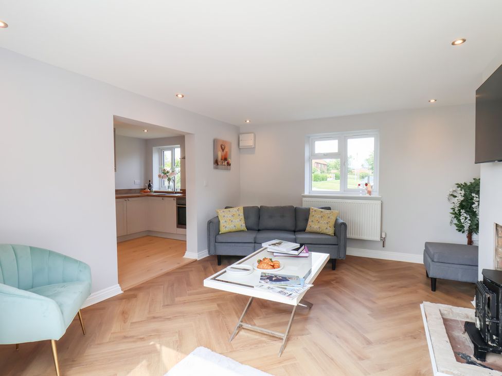 A living room with a sofa and coffee table at Manor Cottage Harpham near Nafferton