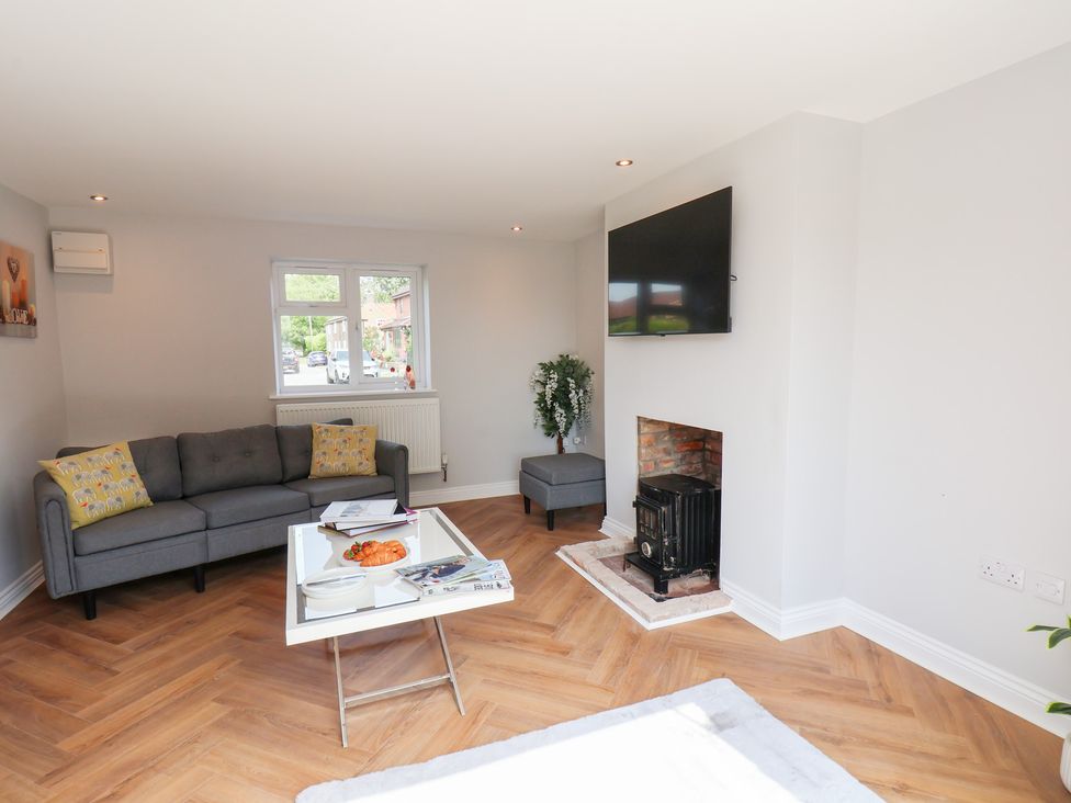 A living room with a sofa and television at Manor Cottage in Harpham near Nafferton
