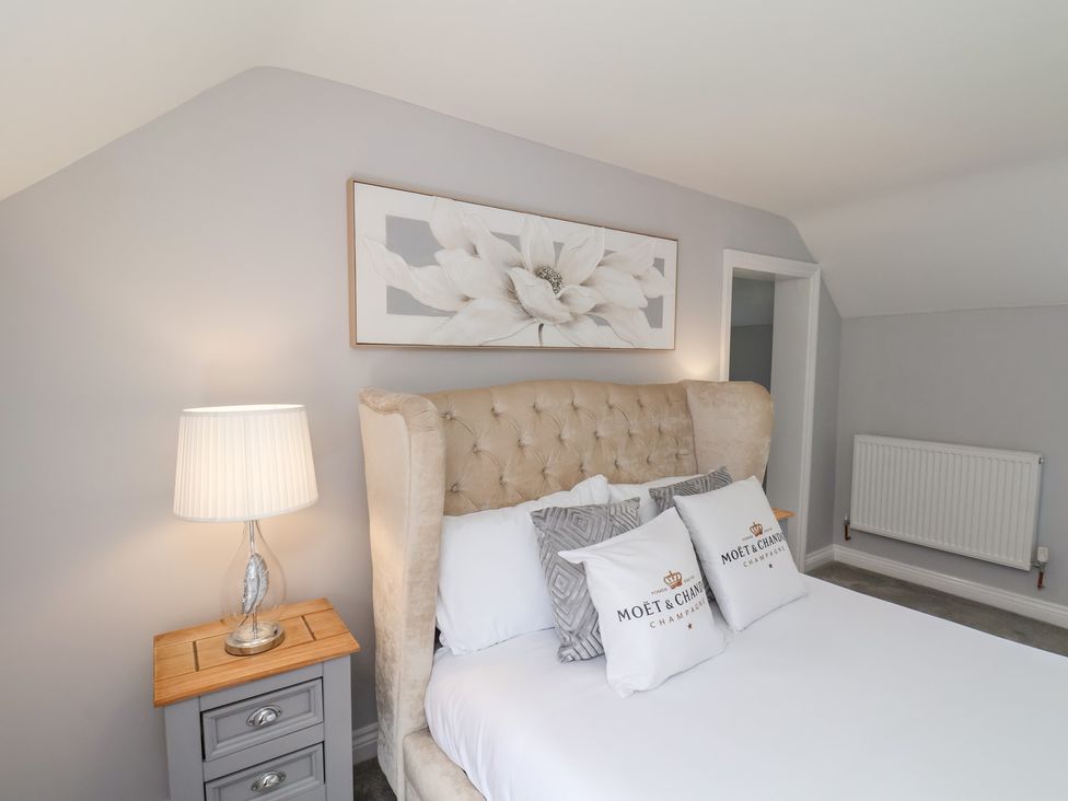 A bedroom with a bed and bedside table at Manor Cottage Harpham near Nafferton