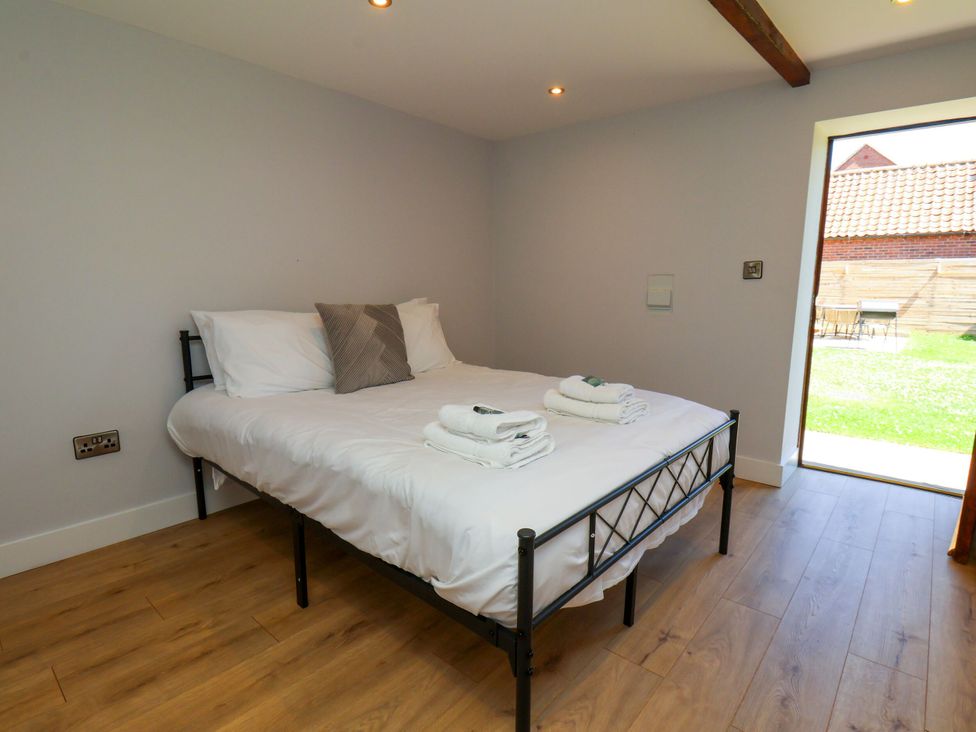 A bedroom with a bed and towels at Manor Cottage in Harpham near Nafferton