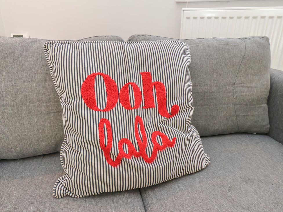 A cushion with text on a sofa at Manor Cottage Harpham near Nafferton