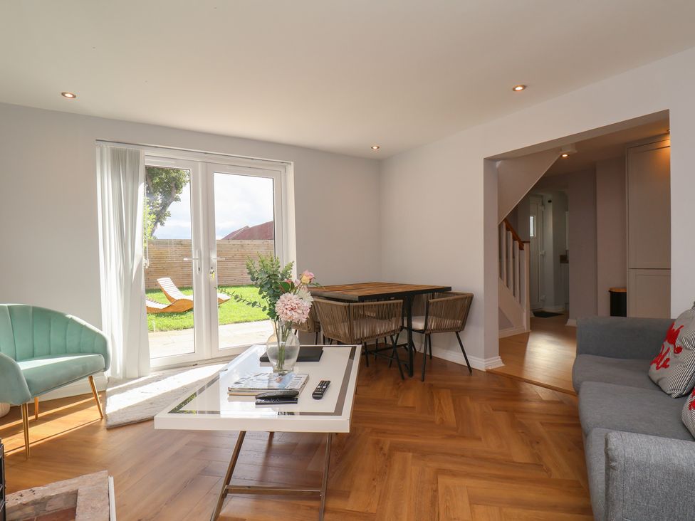 A living room with a sofa and dining table at Manor Cottage Harpham near Nafferton