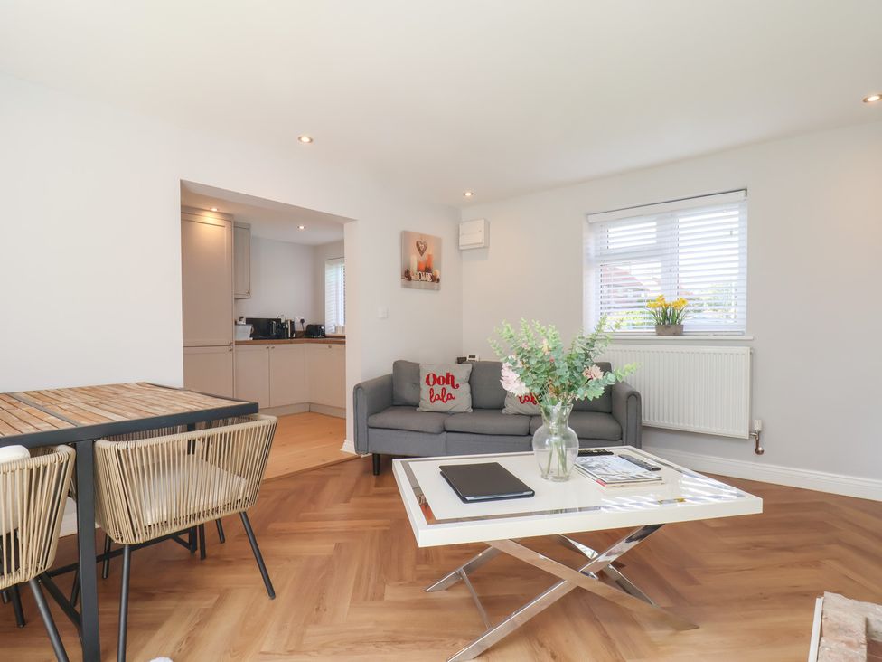 A living room with a sofa and coffee table at Manor Cottage in Harpham near Nafferton