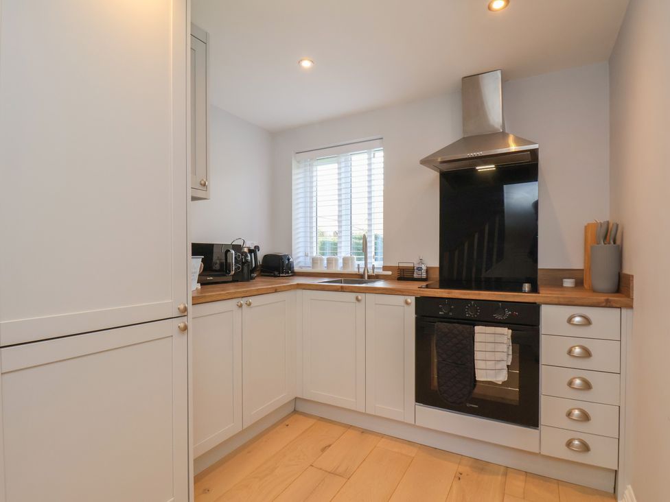A kitchen with cabinets and appliances at Manor Cottage Harpham near Nafferton