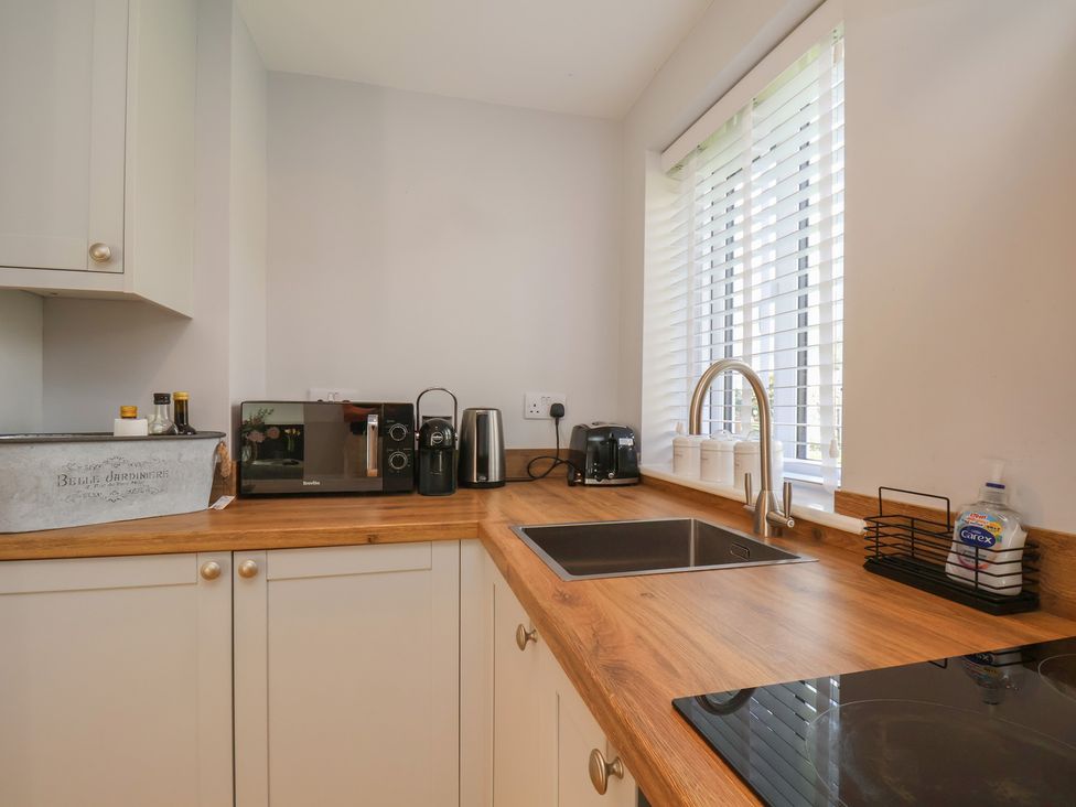 A kitchen with appliances on counter at Manor Cottage in Harpham near Nafferton
