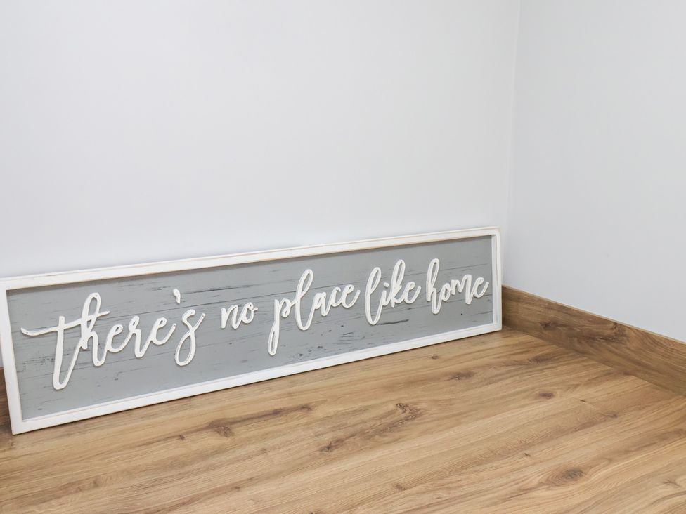 A wooden sign that says there's no place like home in a room in Manor Cottage Harpham near Nafferton