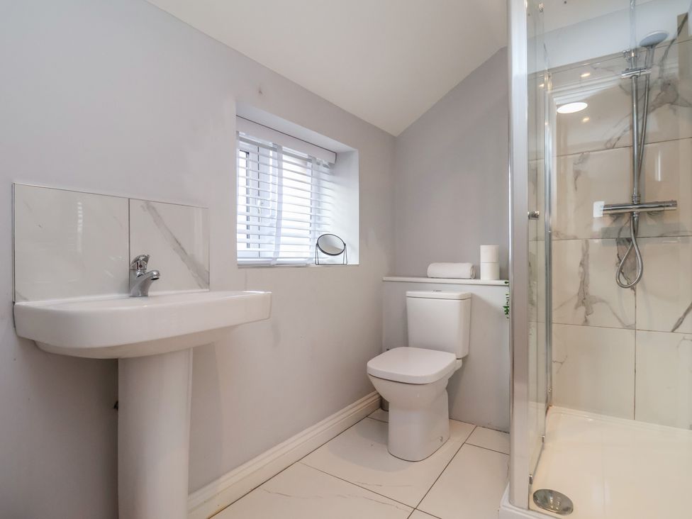 A bathroom with a wash basin, toilet and shower at Manor Cottage Harpham near Nafferton