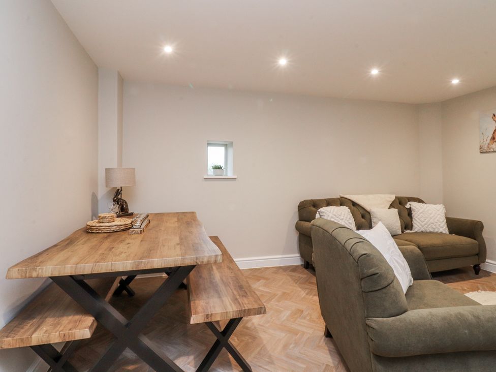 A living room with a table and sofa at Henside Cottage Settle