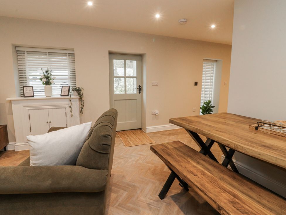 A dining room with sofa and table at Henside Cottage in Settle
