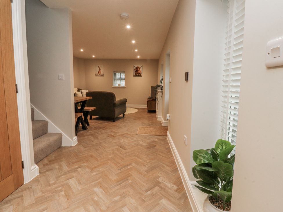 A living room with a sofa and a table at Henside Cottage Settle