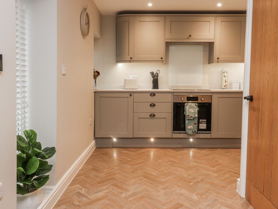 A kitchen with countertop and oven at Henside Cottage in Settle