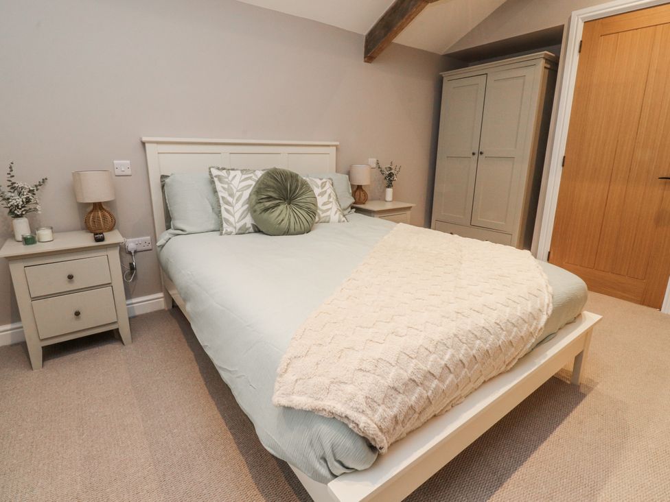 A bedroom with a bed and nightstands at Henside Cottage in Settle