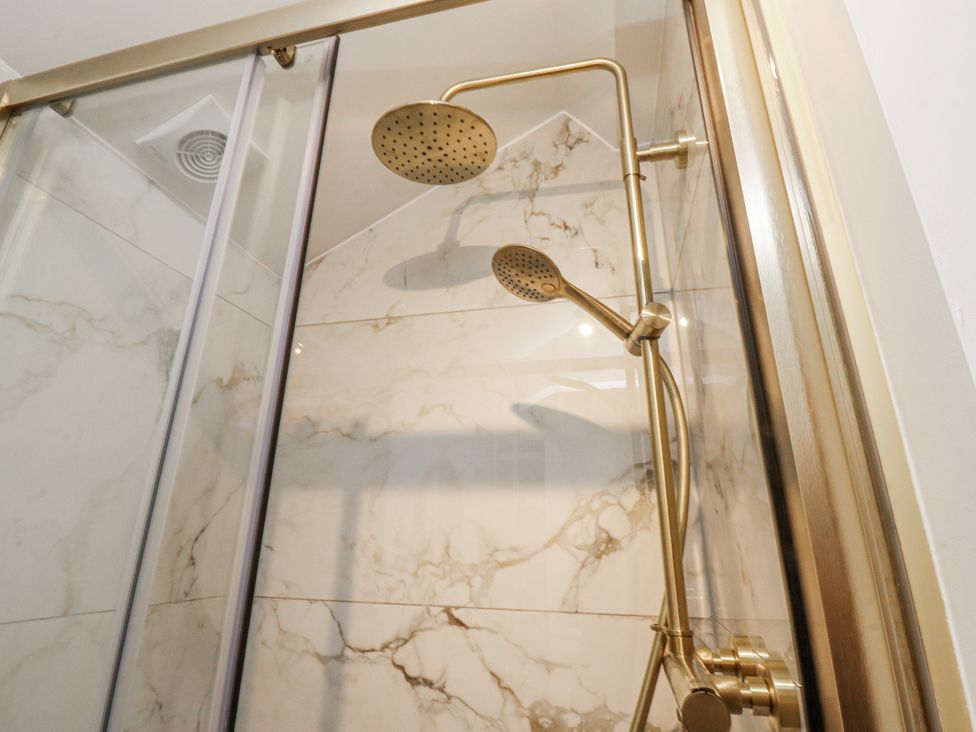 A shower with dual showerheads at Henside Cottage Settle