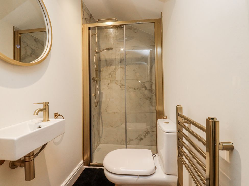 A bathroom with shower and sink at Henside Cottage in Settle