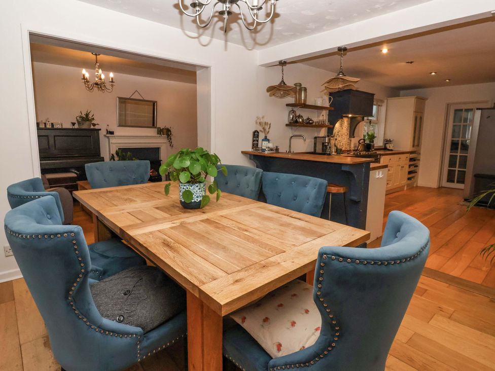 A dining room with a wooden table and chairs at Lair Close House in Harrogate