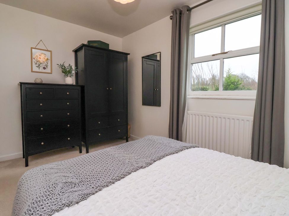 A bedroom with a bed and a dresser at Lair Close House in Harrogate