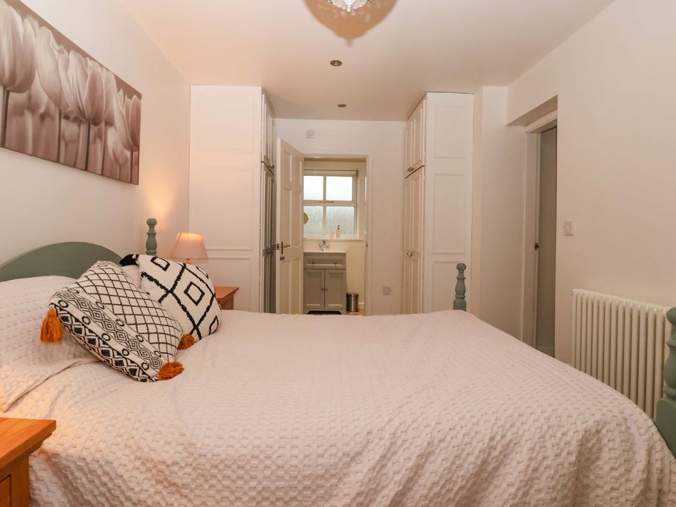 A bedroom with a bed and wardrobe at Lair Close House in Harrogate