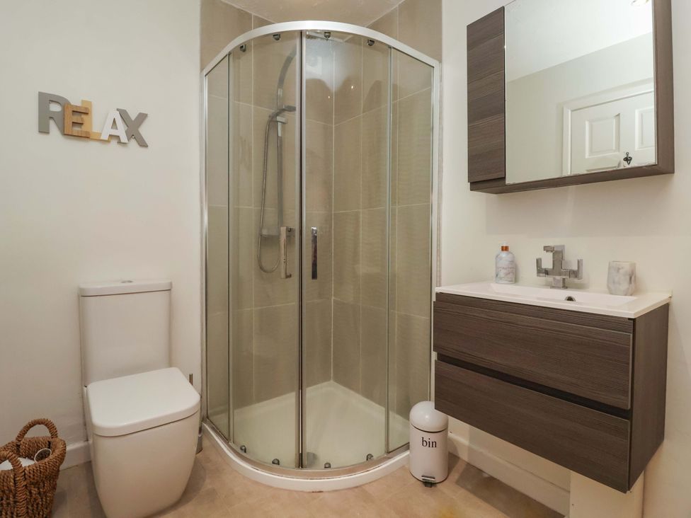A bathroom with a shower and vanity unit at Lair Close House Harrogate