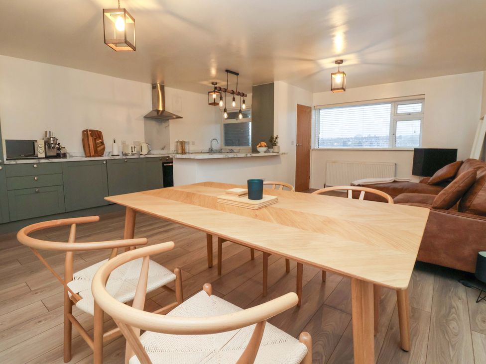 A dining room with a table and chairs at Apartment in Harrogate