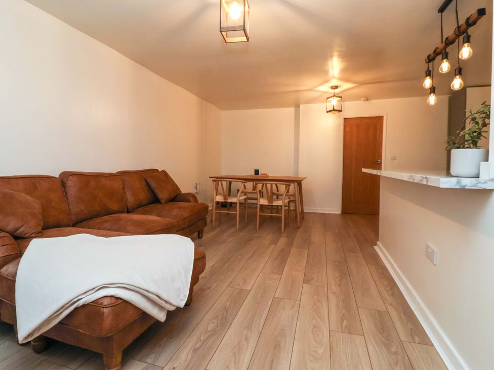 A living room with a sofa and dining table at Apartment in Harrogate