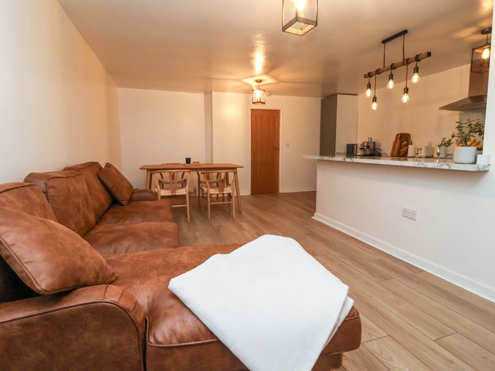 A living room with a sofa and dining table at Apartment in Harrogate