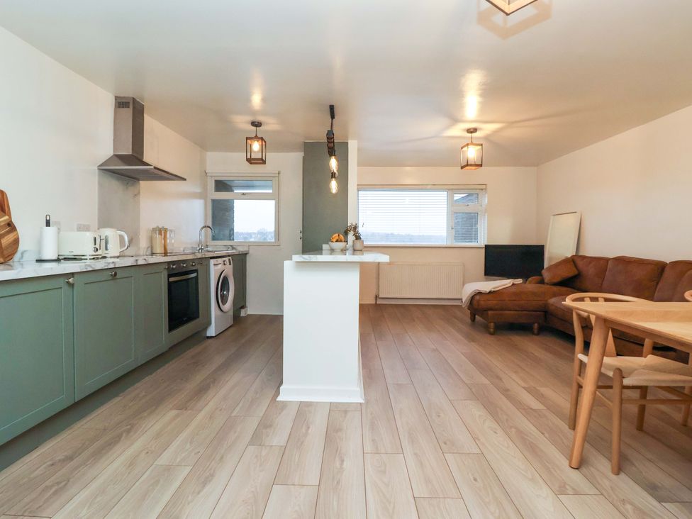 A kitchen with dining area and living space at Apartment in Harrogate