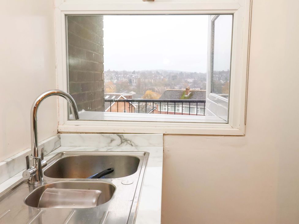 A kitchen sink with a view at Apartment in Harrogate