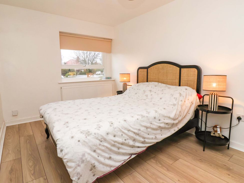 A bedroom with a bed and bedside tables at Apartment in Harrogate