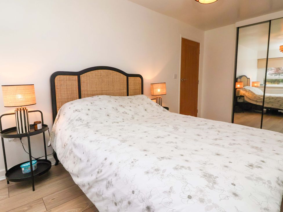 A bedroom with a bed and side tables at Apartment in Harrogate