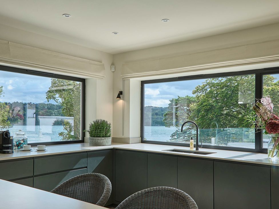 A kitchen with a sink and coffee machine at Craig y Don in Glyngarth near Llandegfan