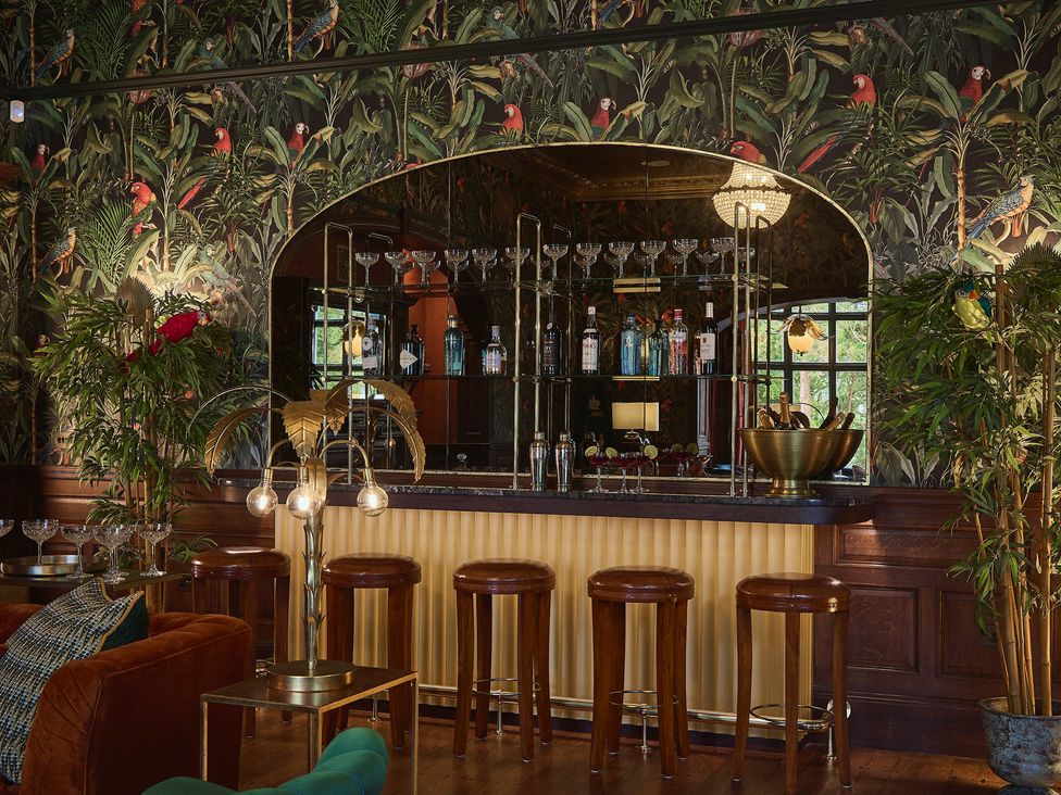 A bar with stools and bottles on display at Craig y Don in Glyngarth near Llandegfan