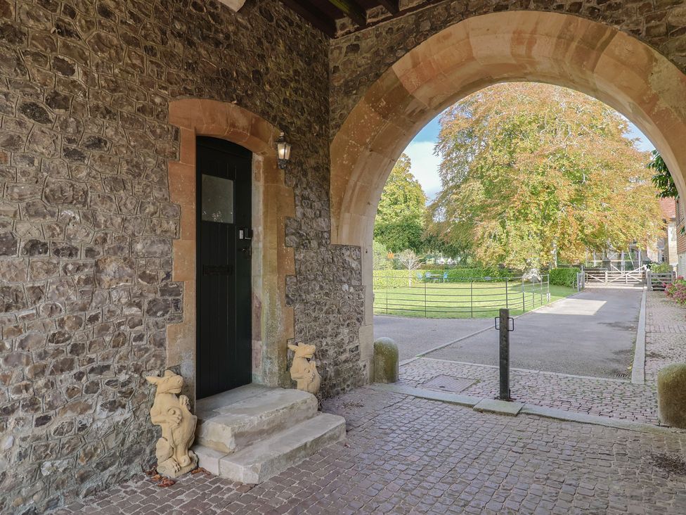 An entrance with a stone wall and a door at The Clock Tower in Rousdon, Nr Lyme Regis