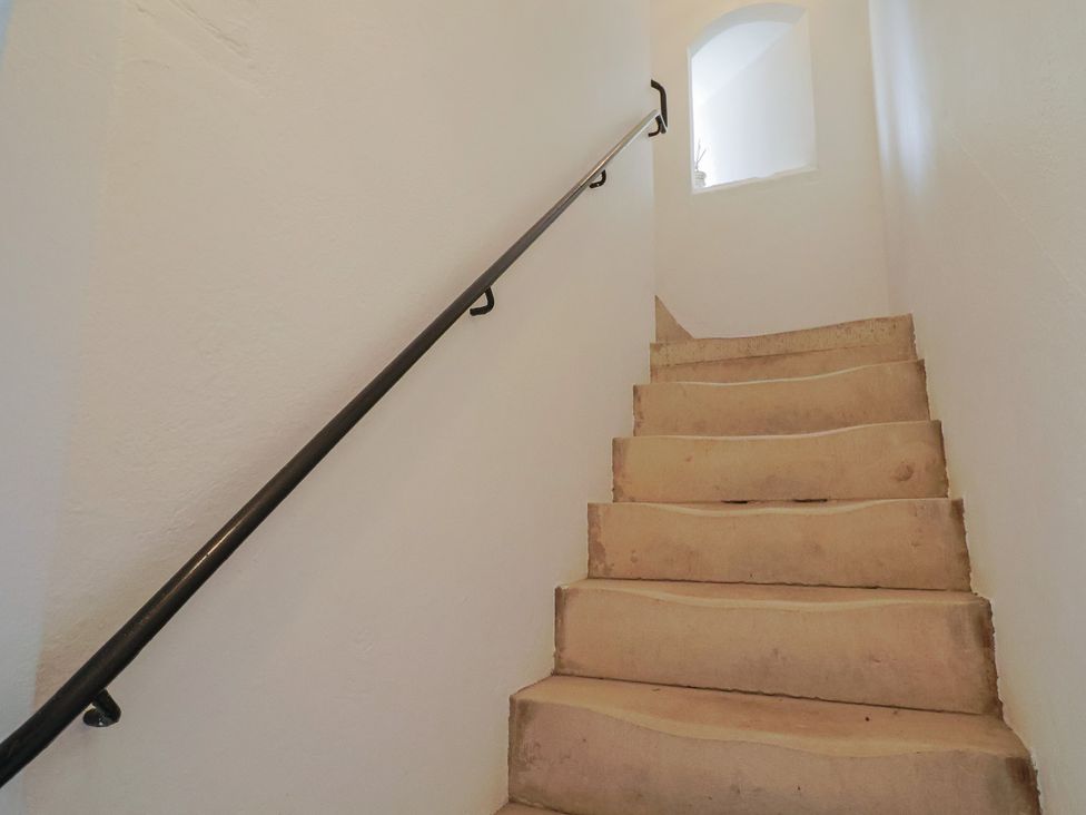 A staircase with a handrail at The Clock Tower in Rousdon, Nr Lyme Regis